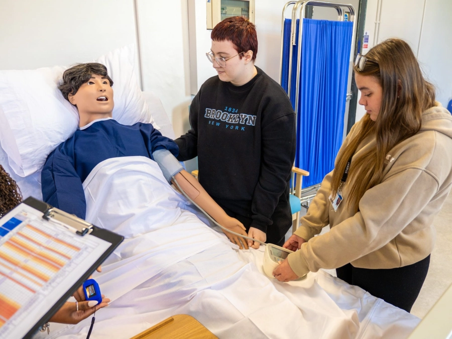 Students practicing taking blood pressure readings jpg