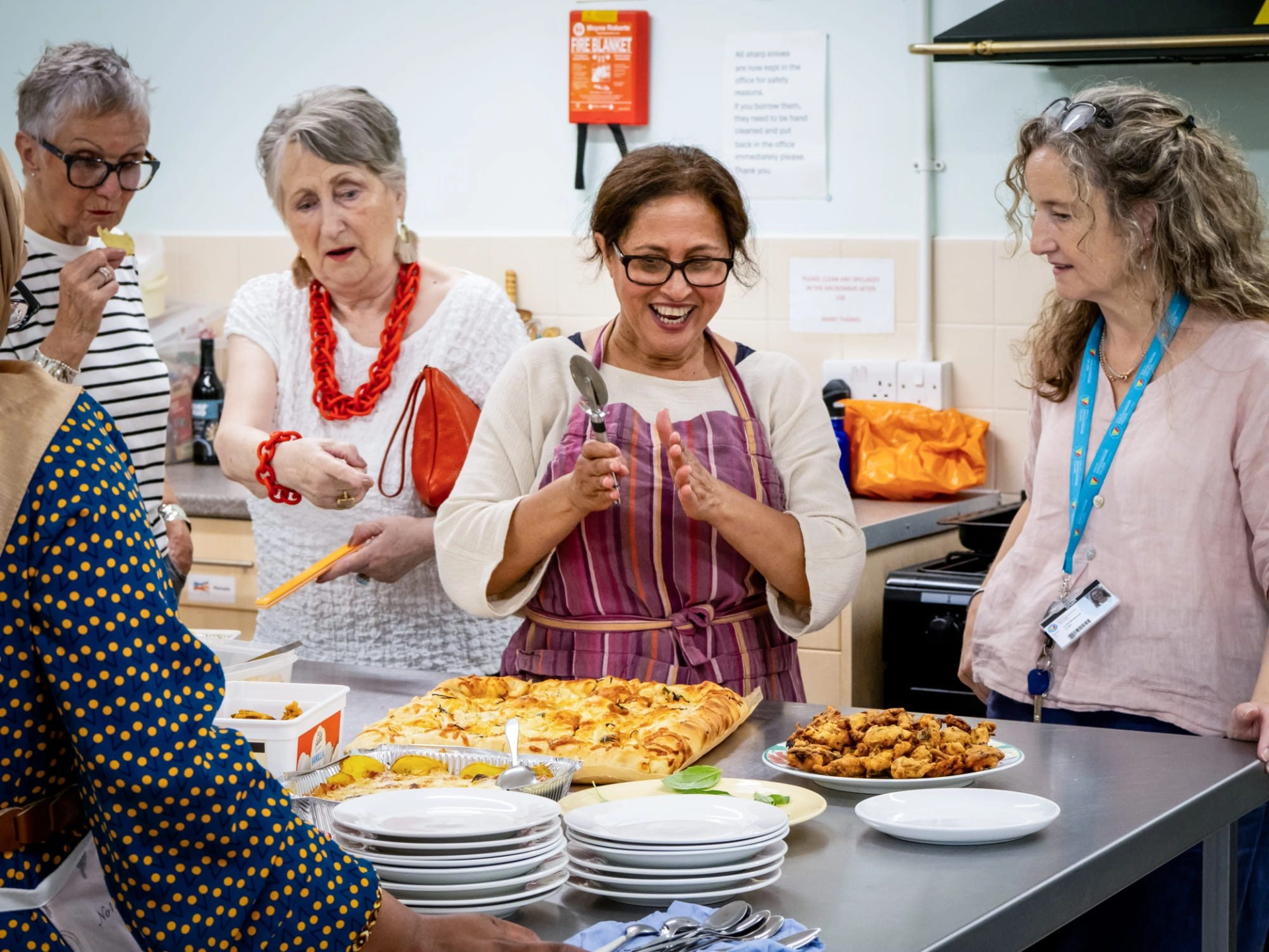 Adults in cooking class with food on table