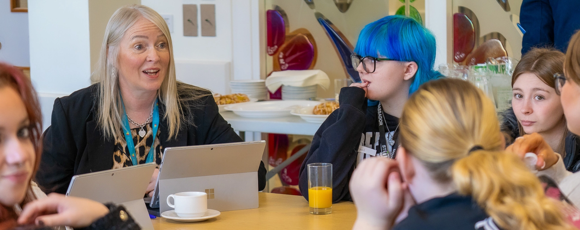 Group of Students talking to College Staff member