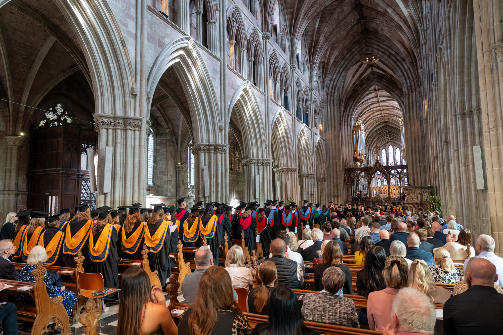 Group of graduands sitting in a cathedral