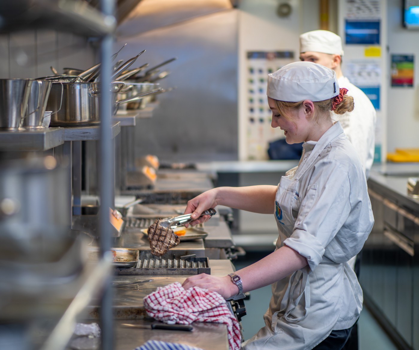Apprentice cooking meat