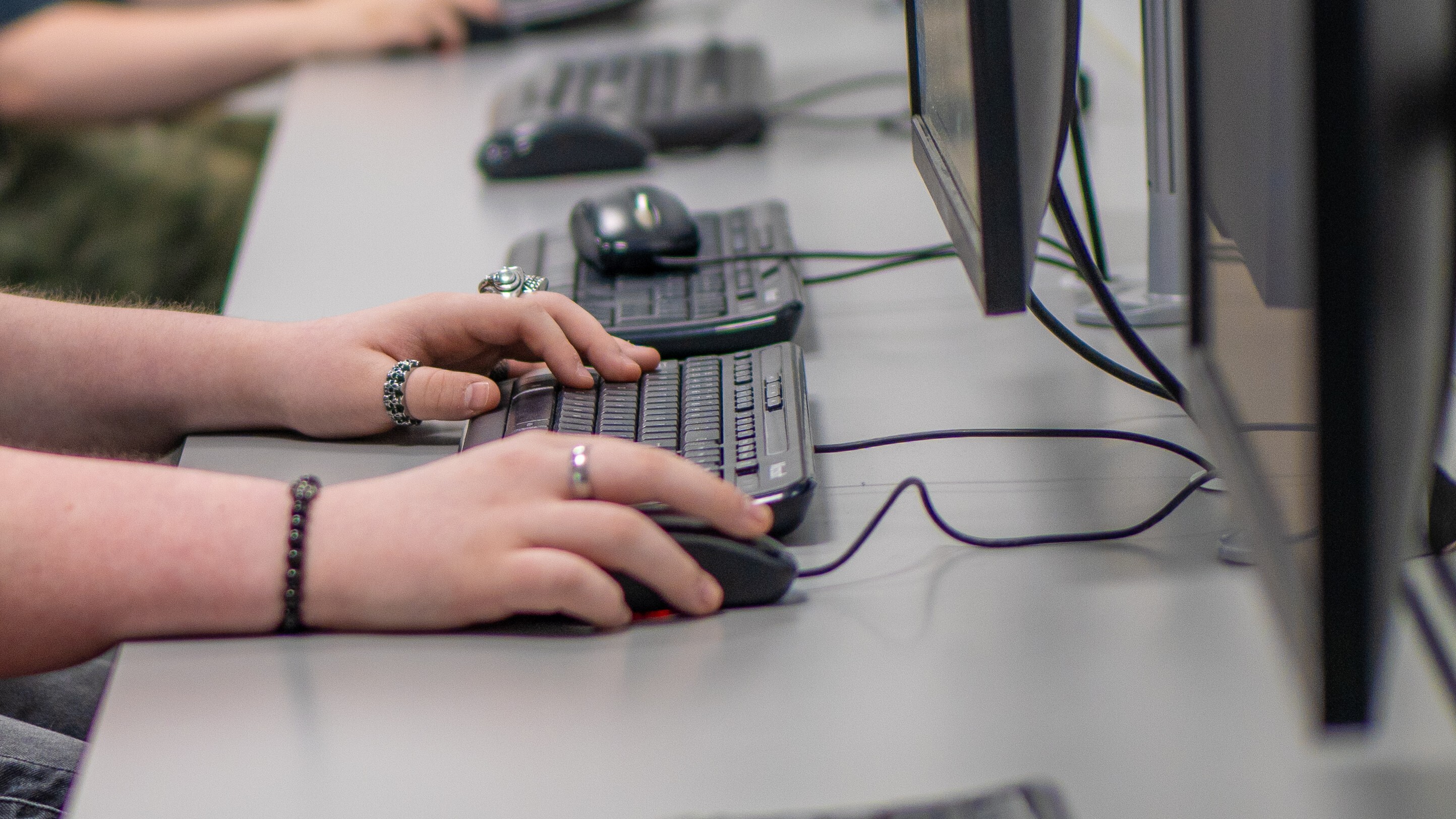 Person typing on a keyboard.