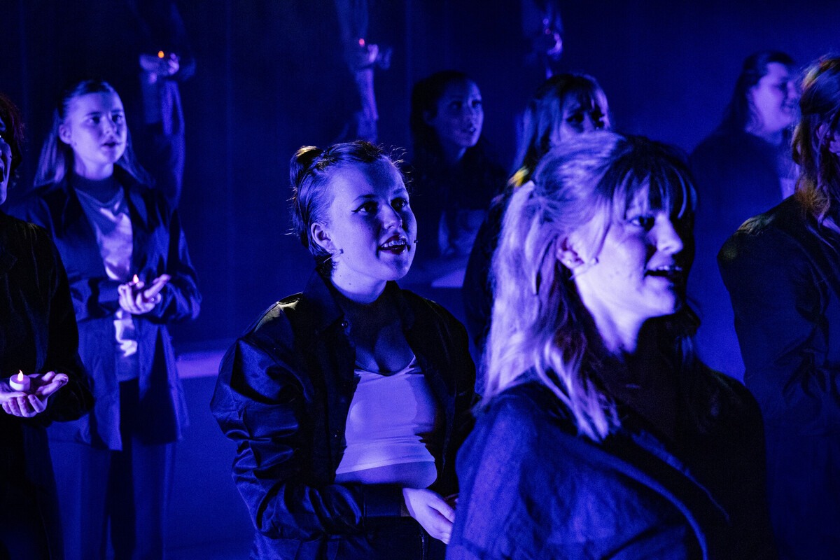 Performing arts students singing on stage during their showcase