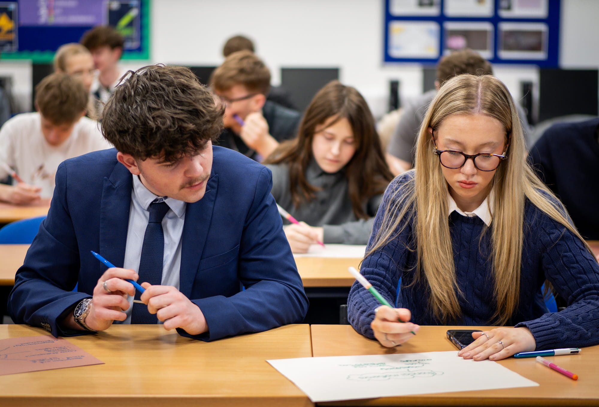 Students sat at desk working together