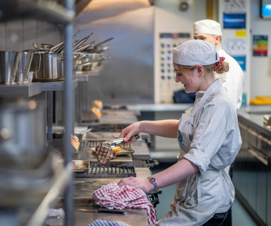 Apprentice cooking meat