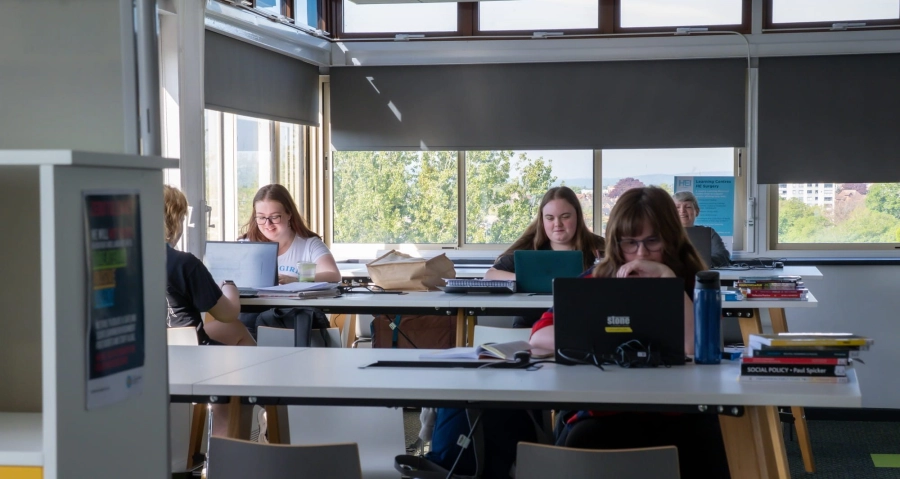 Group of students at desks on laptops