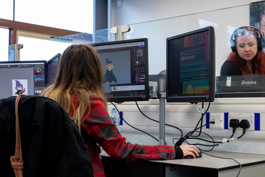 Student working on game on computer in a classroom