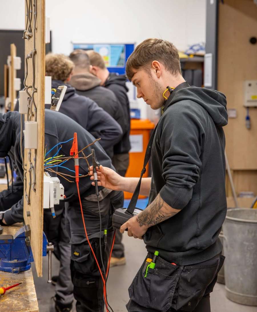 Student cutting a wire in workshop