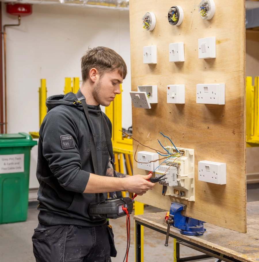 Student wiring a plug socket