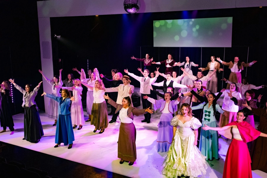 Big group of students performing on stage
