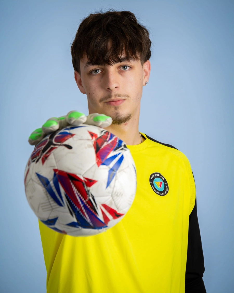 Student holding a football in front of them