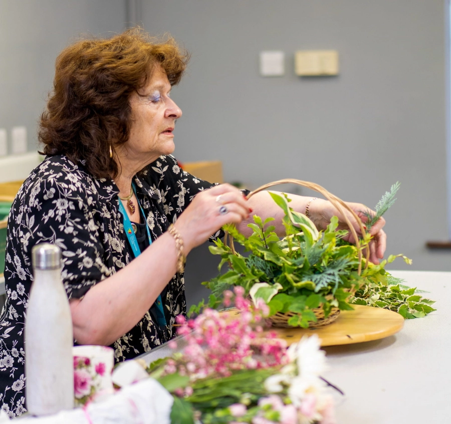 Adult learner doing a flower arrangement in a lesson