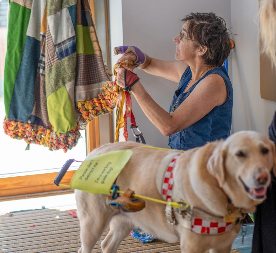 Learner sewing with dog in front of them