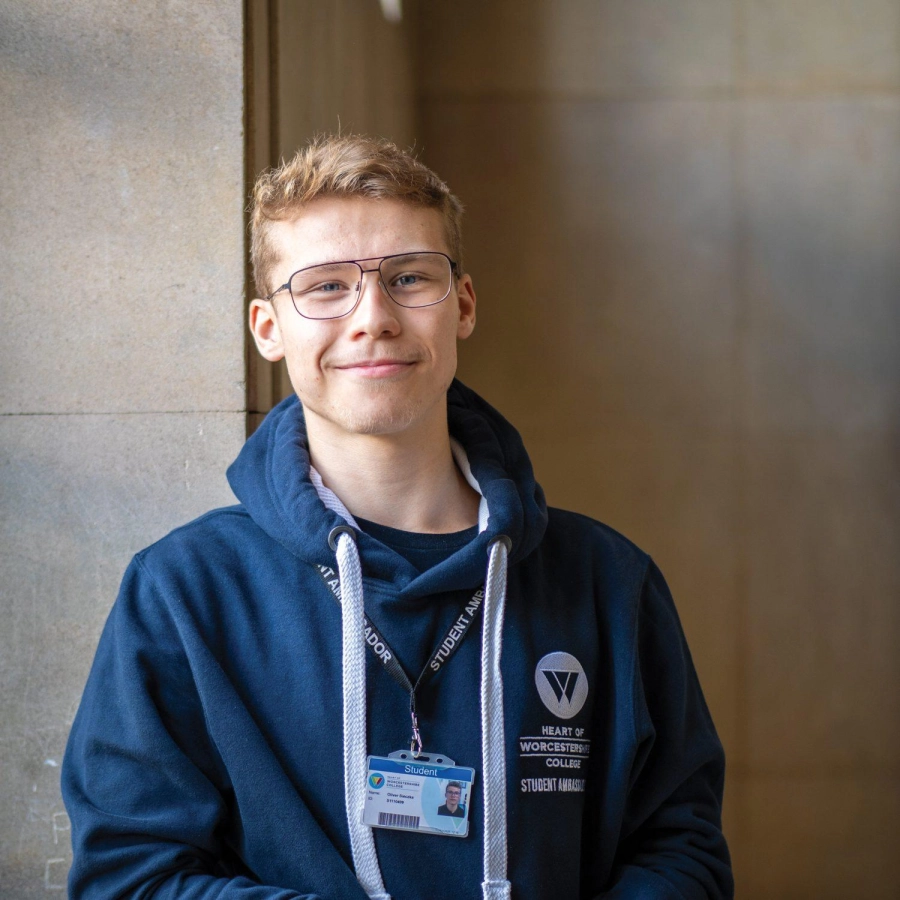 Student leans against windowsill