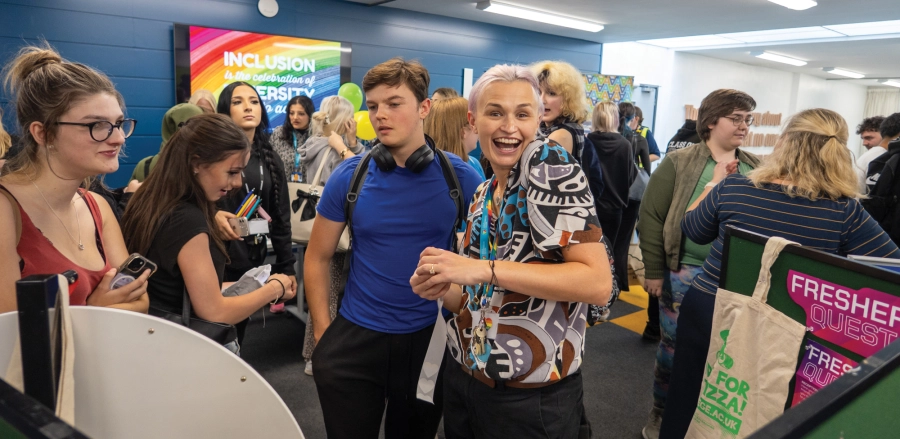 Group of people at a fair with one person staring at the camera smiling