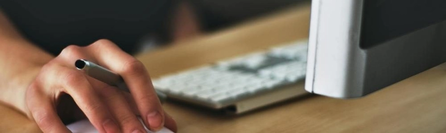 Someone using a mouse with a computer