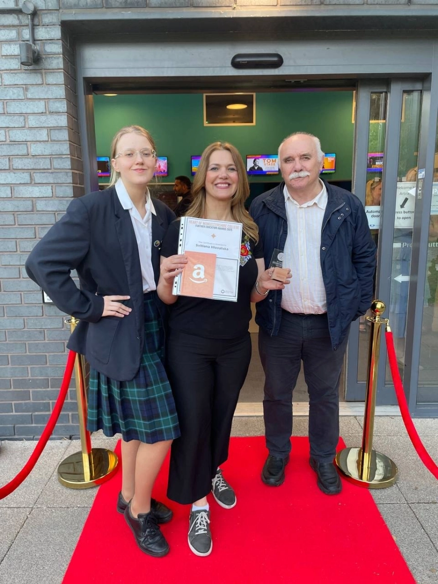 HoW College award winner and family stood on red carpet with her award posing for a picture