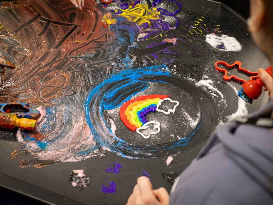 A picture of a students artwork they have done using paint on a table