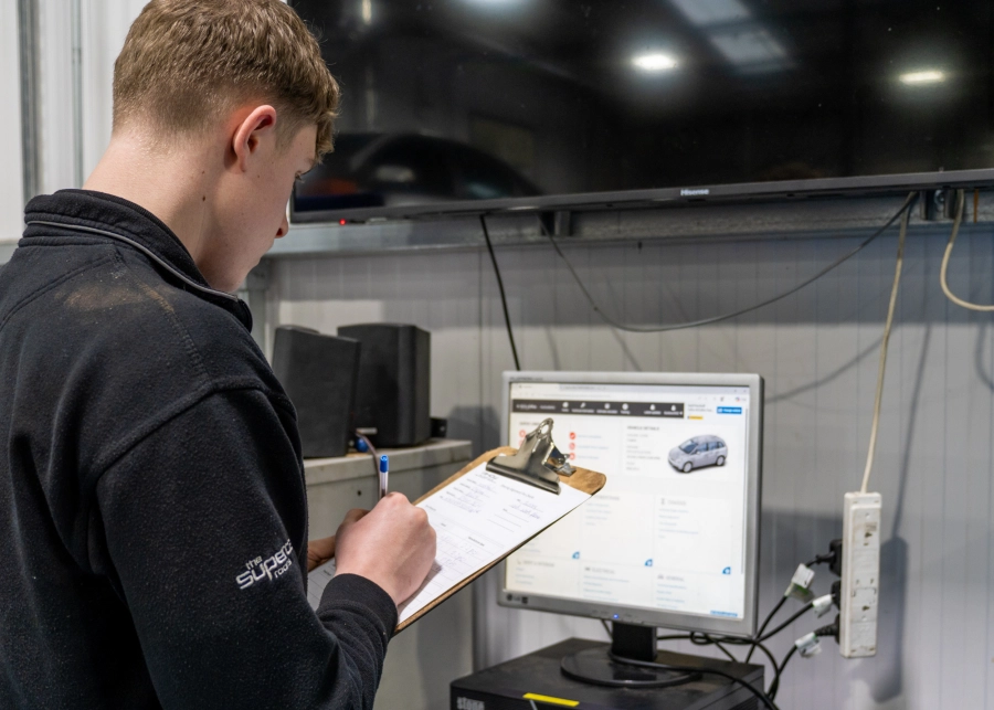 Apprentice writing on a clipboard