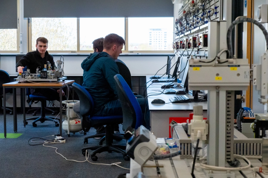 Students in a classroom using equipment