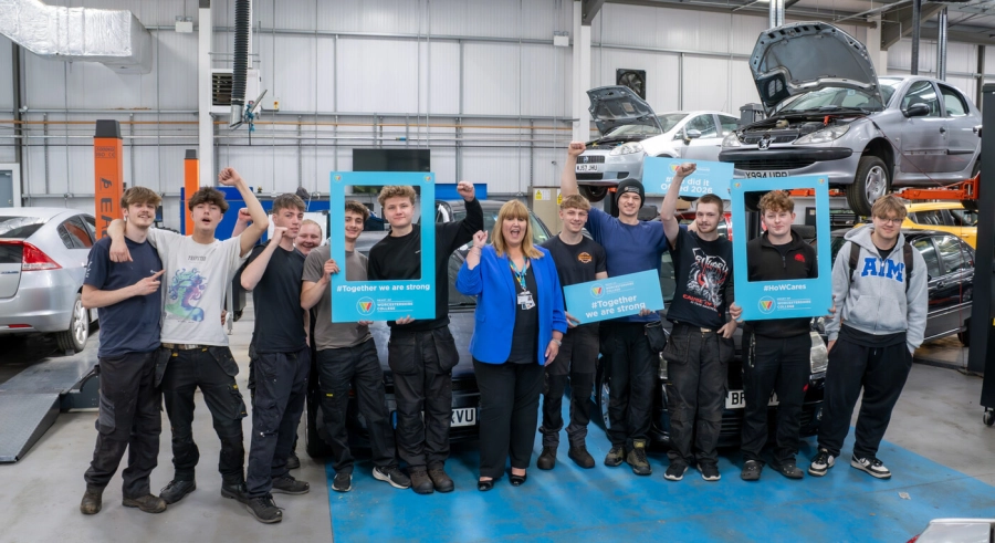 Automotive students in workshop cheering with principal and celebrating the Ofsted results