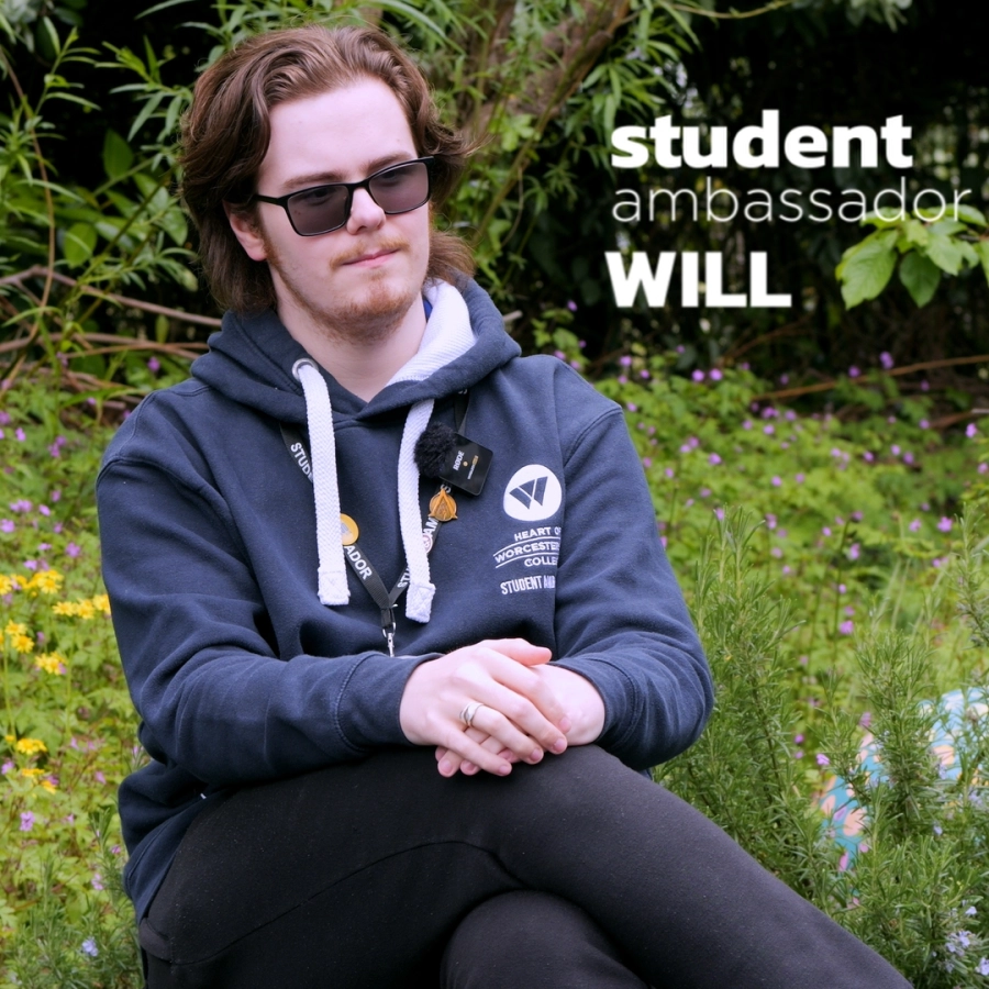 A picture of a HoW College student ambassador names will with their leg crossed posing for a photo