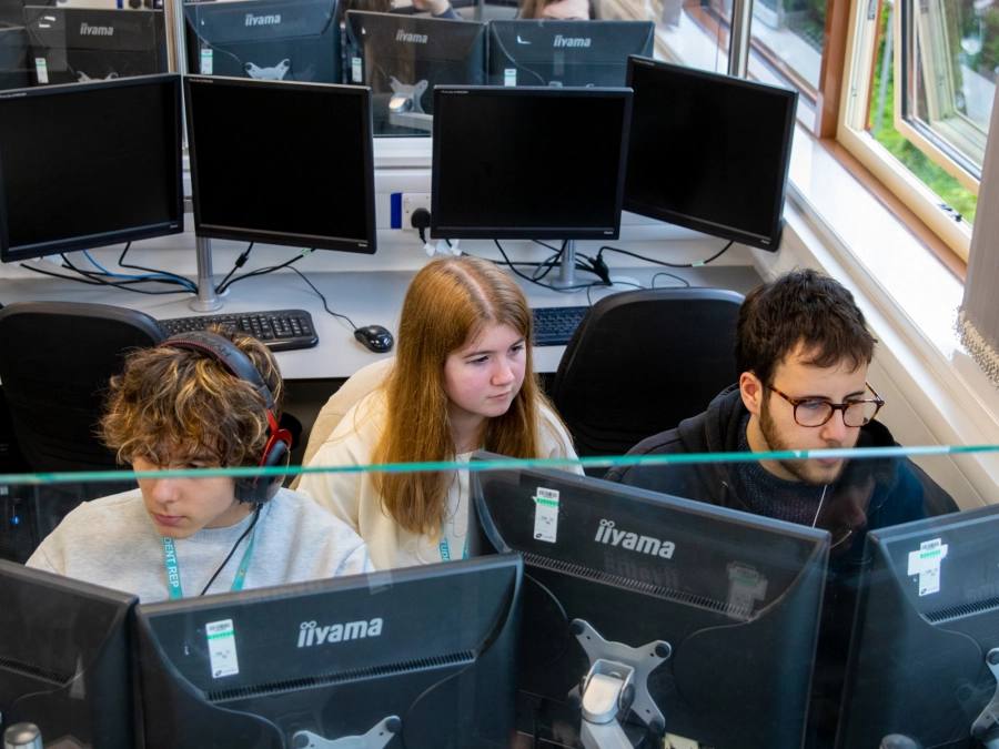 Group of 3 students working on computers