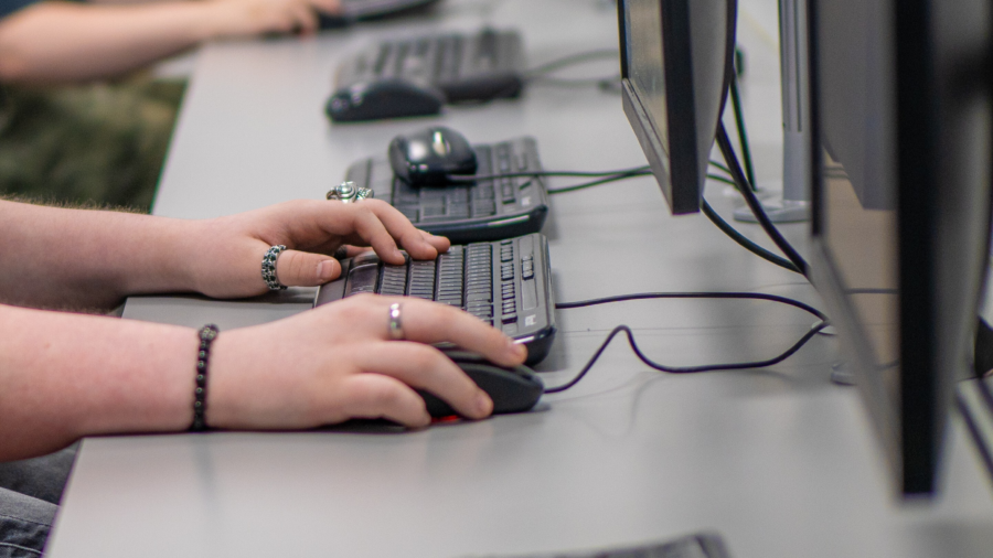 Person typing on a keyboard.