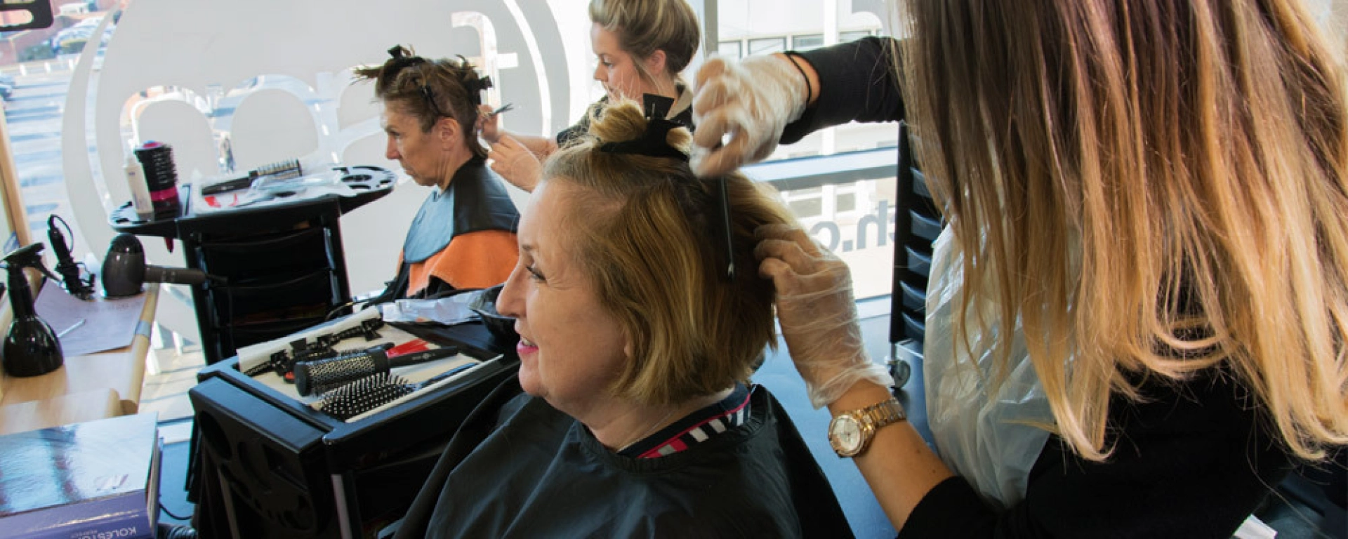 Hairdressing students working on clients