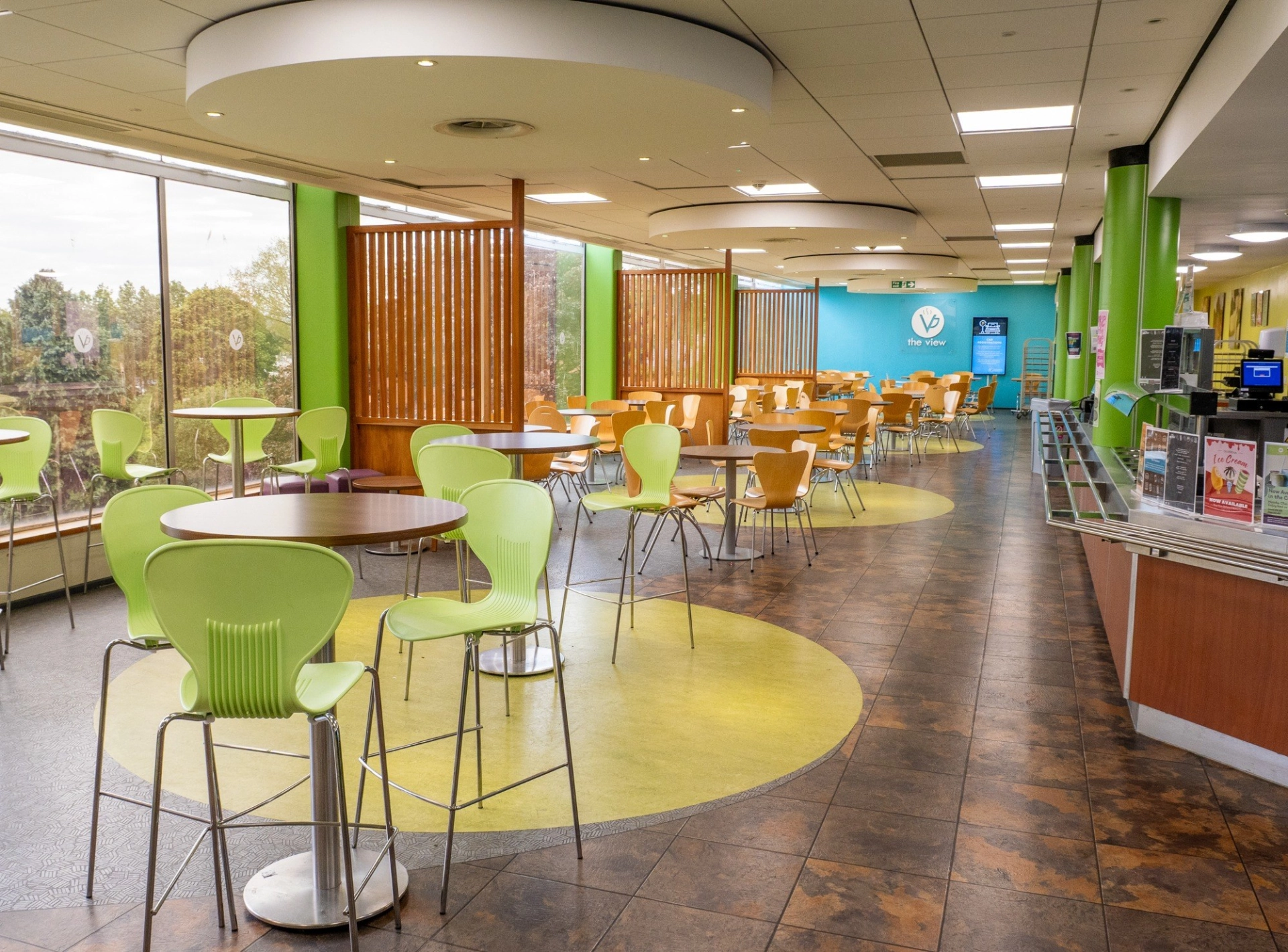 Empty cafe filled with high and low tables
