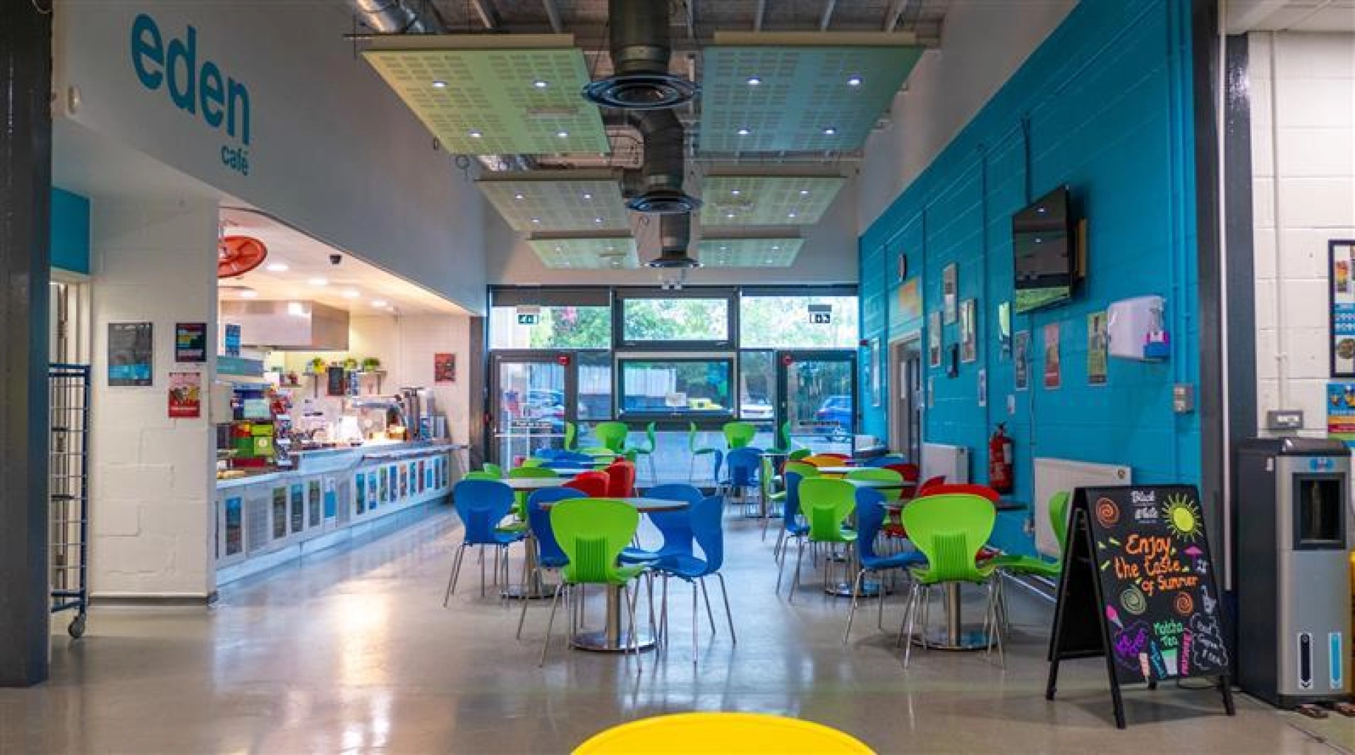 Empty cafe with tables and a hot food counter