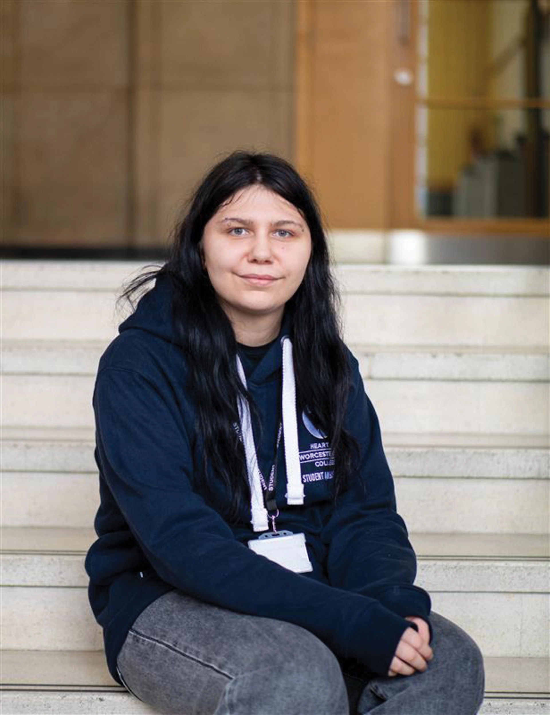 Student sits on marble stairs