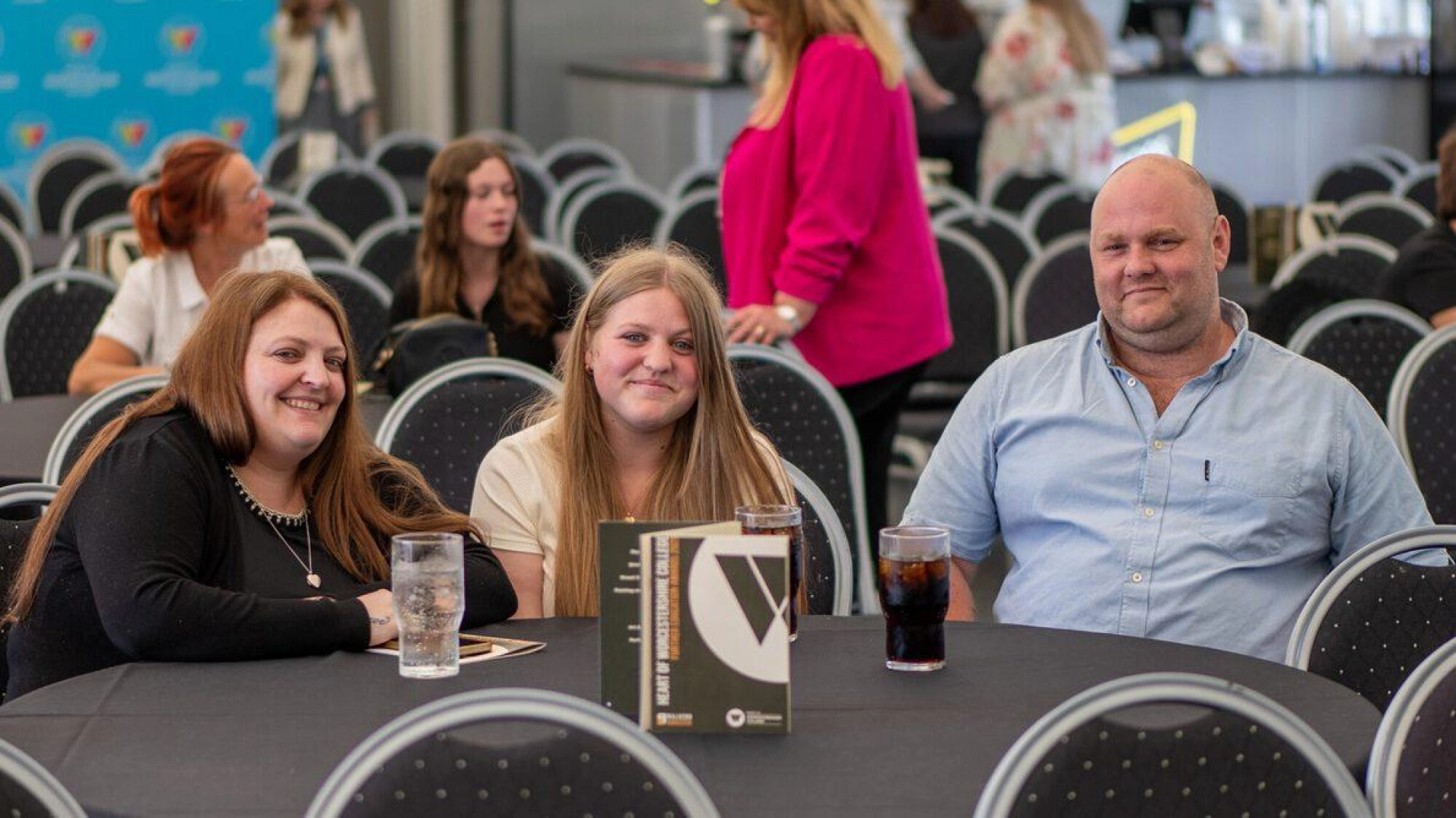 Two parents and a student sit together at a table at the FE Awards